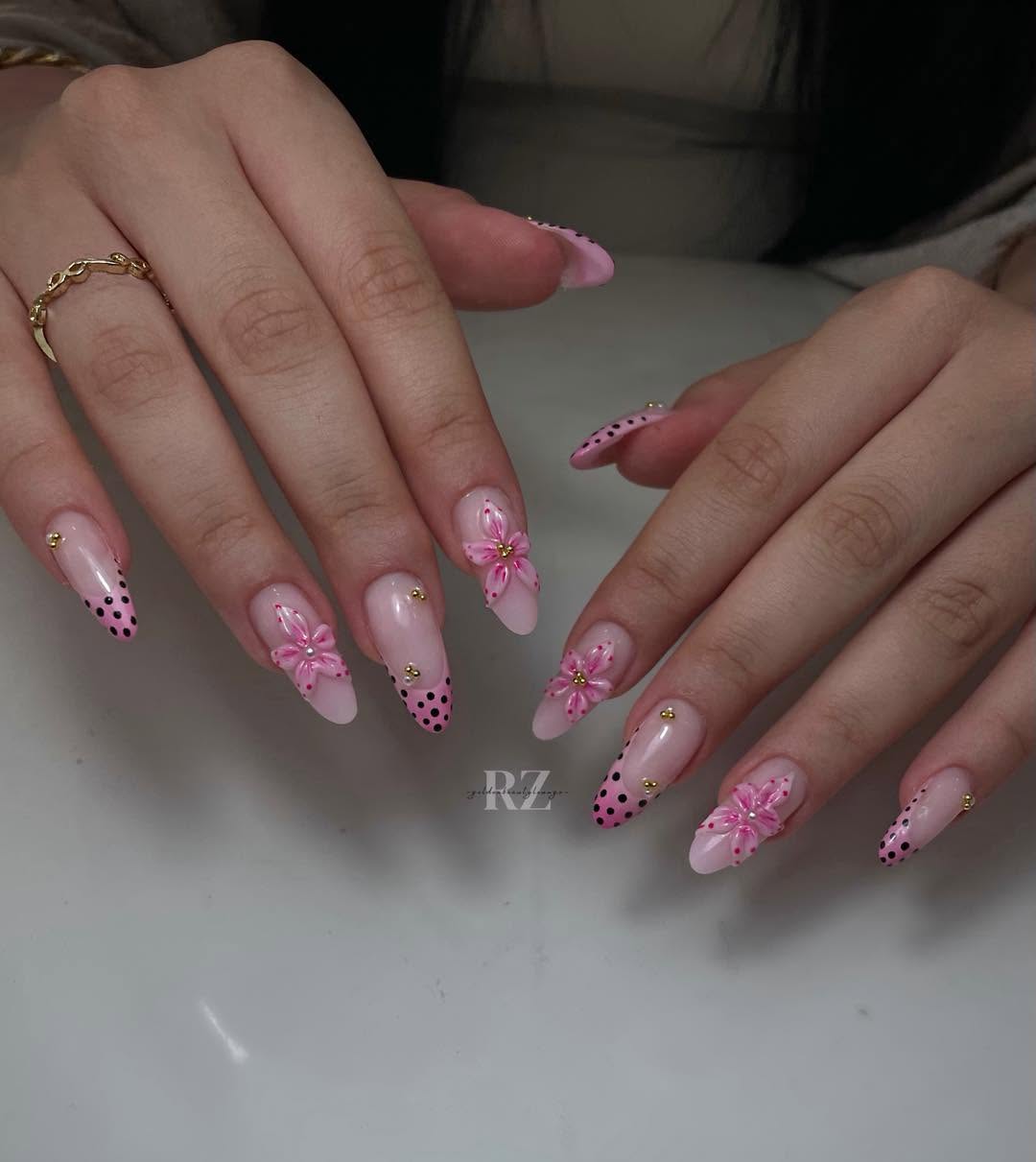 Pink 3D flower almond nails with black polka dot French tips