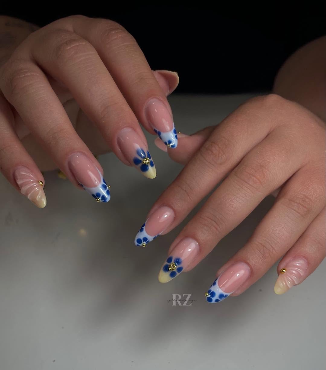Blue and white floral French tip almond nails with gold beads