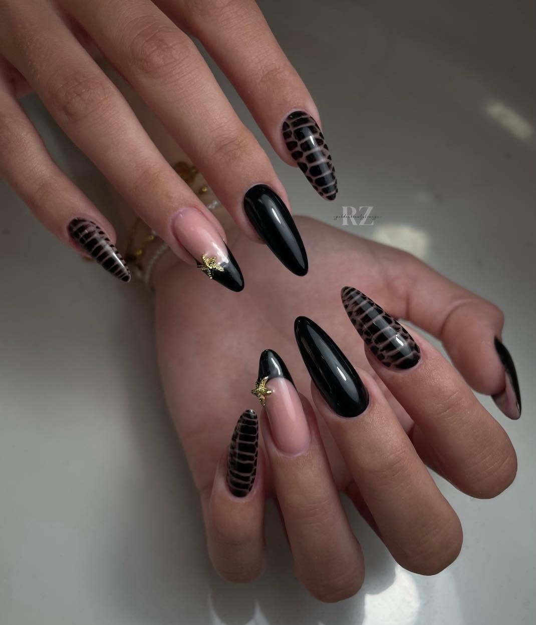 Glossy black and snake print almond nails with gold charms